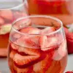 Pinterest graphic for Rosé Sangria. Text says "the best Rosé Sangria make with only 4 ingredients! shakedrinkrepeat.com" Image shows a glass of rose sangria with fresh strawberries.
