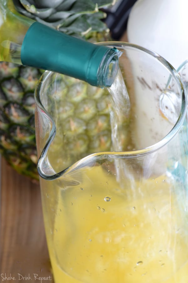 This easy Pina Colada Sangria Recipe comes together with only three ingredients! It is the perfect party drink! Make a double batch because it is that good!