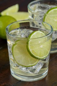 glass of the perfect gin and tonic with two lime slices