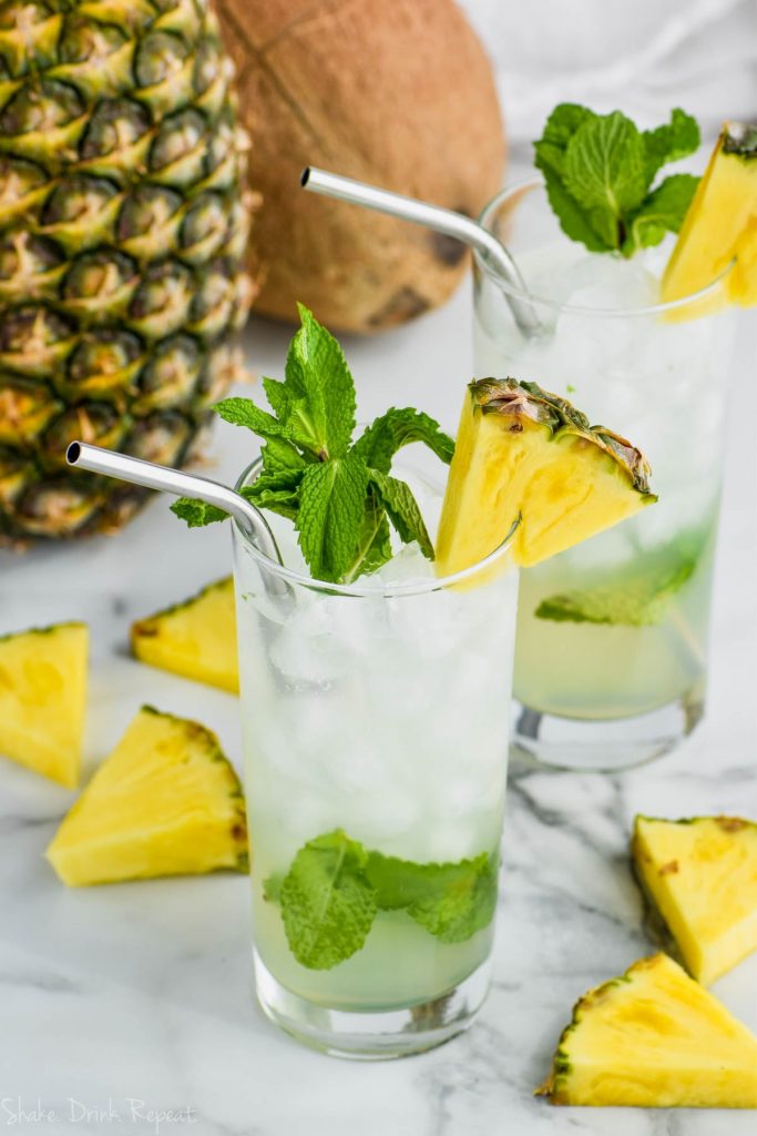 glass of pineapple mojito with pineapple and mint