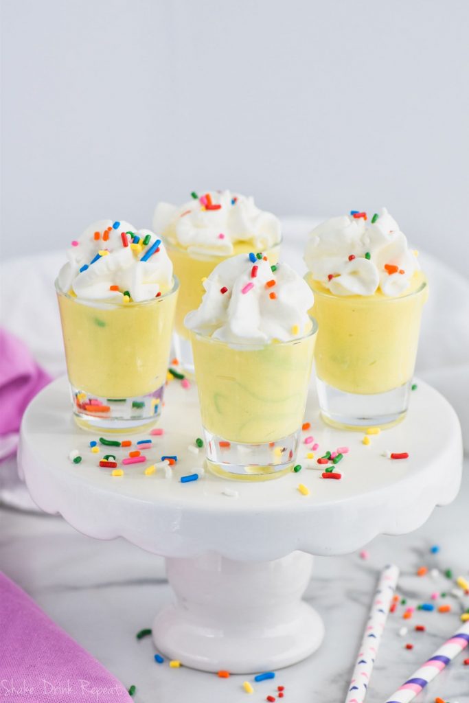 birthday cake pudding shots in shot glasses on cake stand