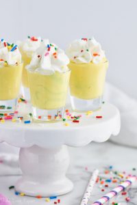 birthday cake pudding shots in shot glasses on cake stand