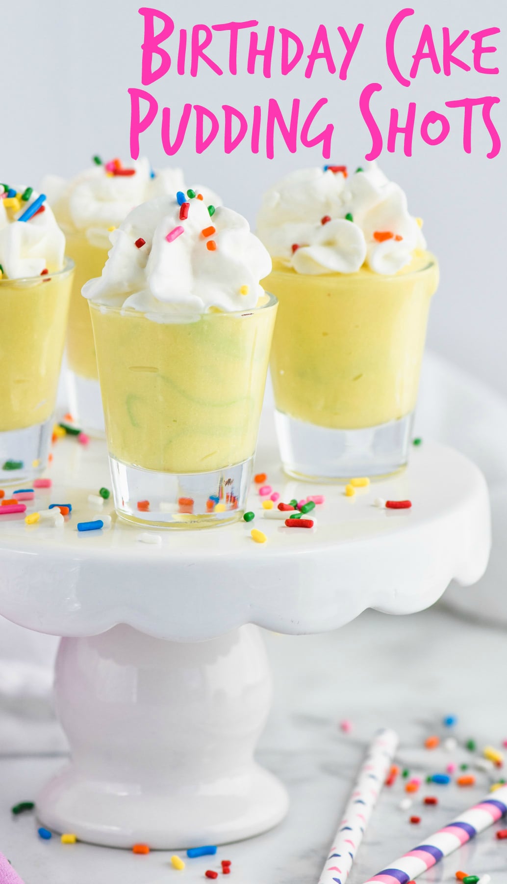 birthday cake pudding shots in shot glasses on cake stand
