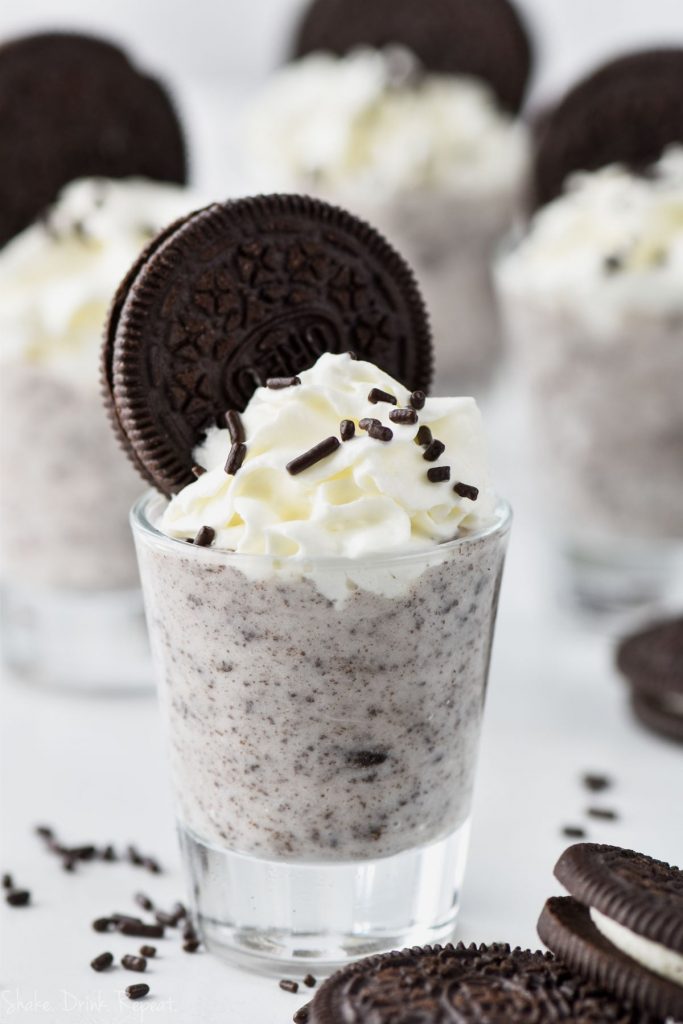 cookies and cream pudding shot recipe in shot glass with whipped cream