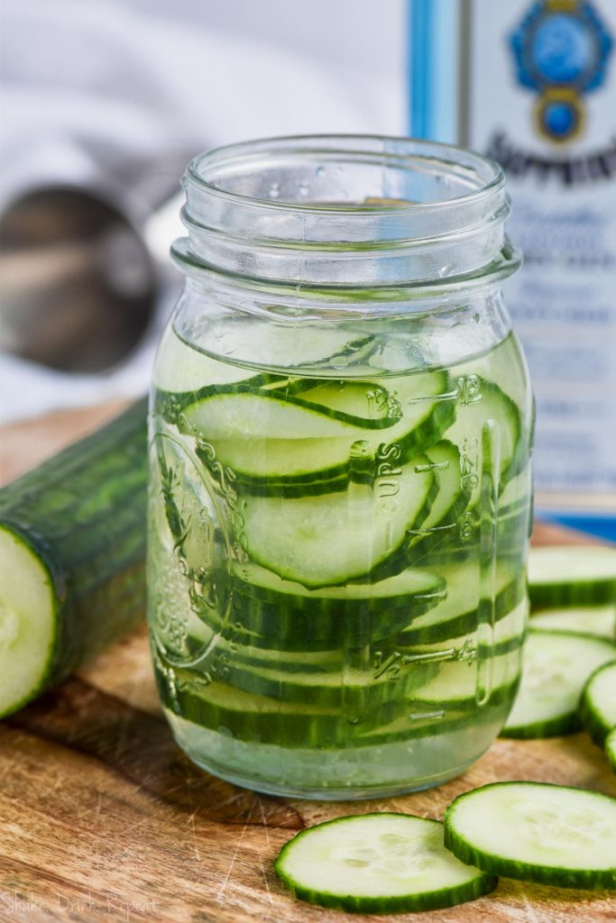 thinly sliced cucumbers in gin