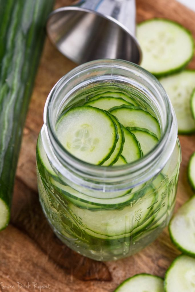 thinly sliced cucumbers in gin