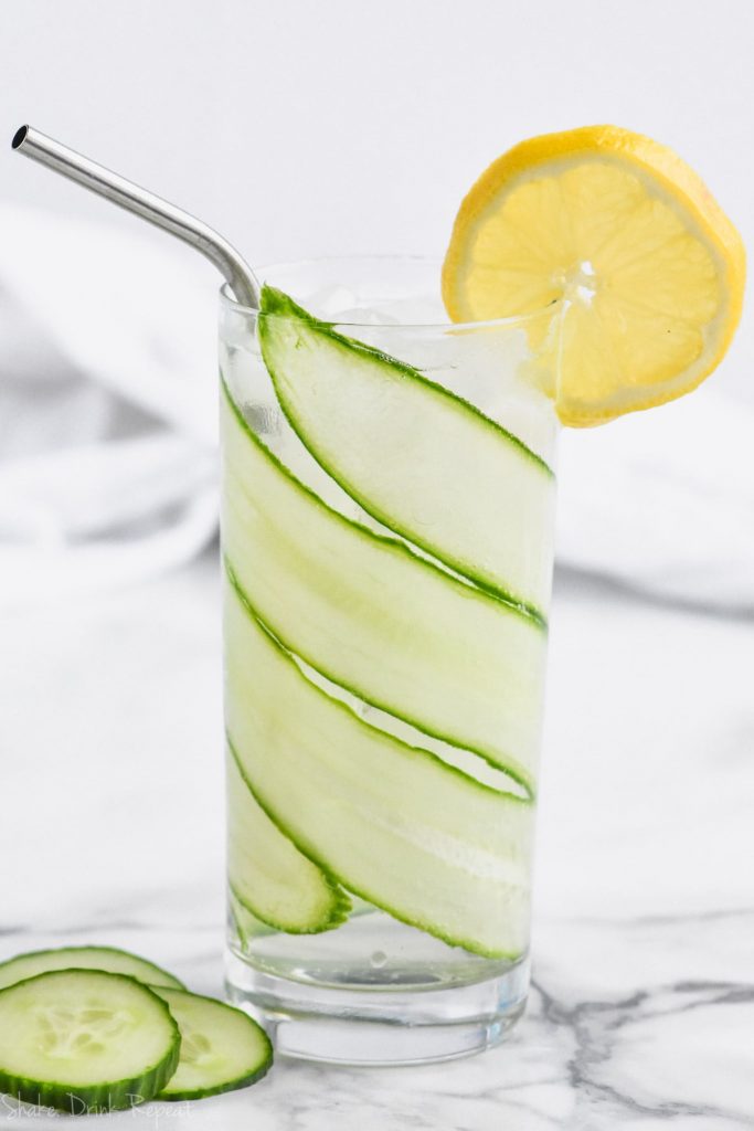 cucumber lemon gin and tonic in tall glass lined with sliced cucumber