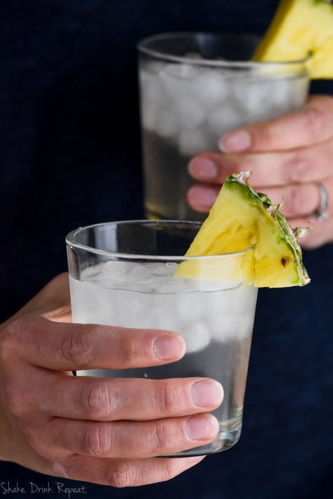 hand holding a pineapple vodka soda