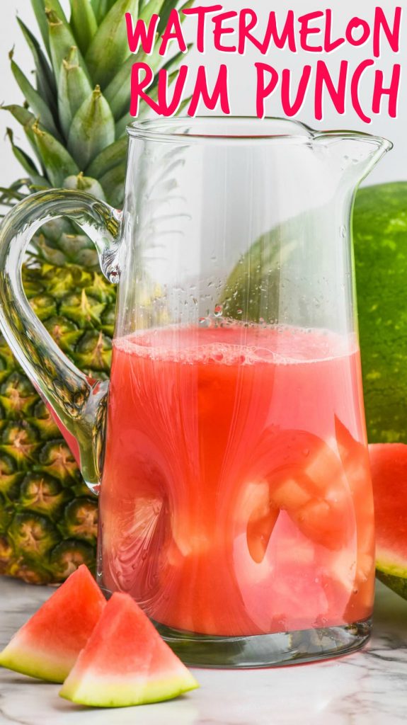 pitcher of watermelon rum punch cocktail with floating pineapple