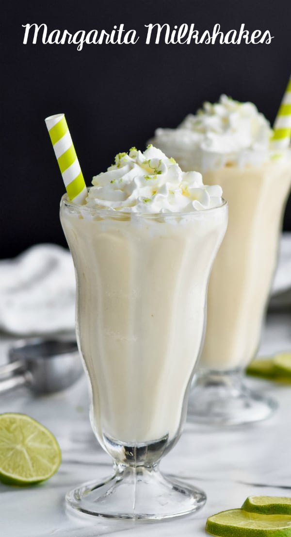 margarita milkshake in a tall milkshake glass with whipped cream and lime zest