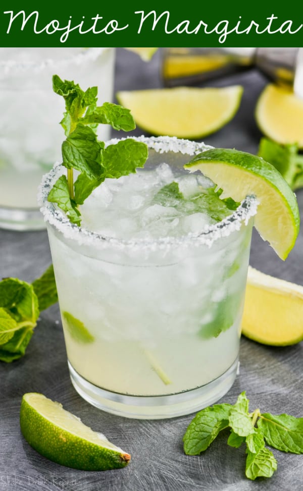 a mojito margarita in a salt rimmed glass with fresh mint and a lime wedge