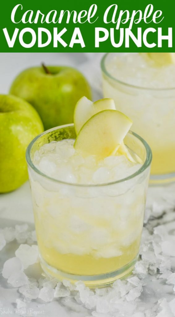 cup of caramel apple vodka punch garnished with sliced apples