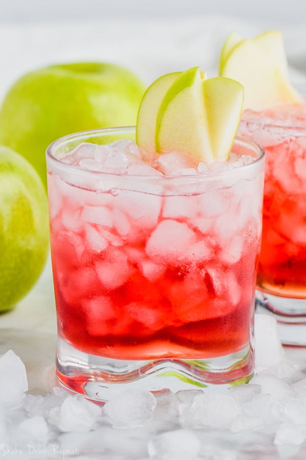 cranberry apple whiskey cocktail garnished with apple