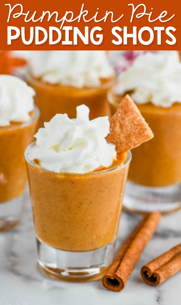 shot glass full of pumpkin pie shot topped with whipped cream