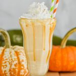 boozy pumpkin milkshake with whipped cream and straws