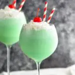 Drink in Tall Glass with straws, cherries and whip cream