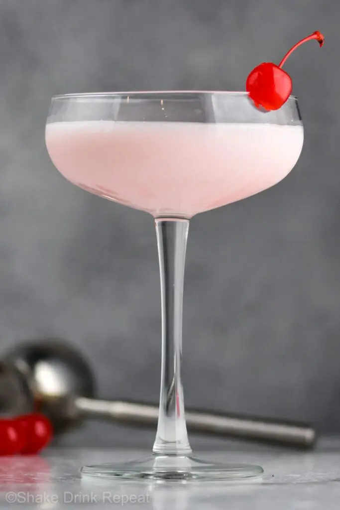 Pink lady drink in a glass with a cherry