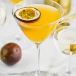 Glass of drink with passion fruit half in it
