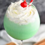 Drink in Tall Glass with straws, cherries and whip cream