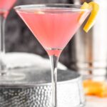 Cosmopolitan Cocktail in a glass garnished with a lemon twist