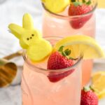 Drunk Bunny Cocktail in glass with ice, peep, lemon wedge and strawberry.