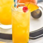 glass of Harvey Wallbanger with straws, orange wedge and cherry garnish