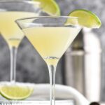 two martini glasses Kamikaze Drink with lime wedge garnish