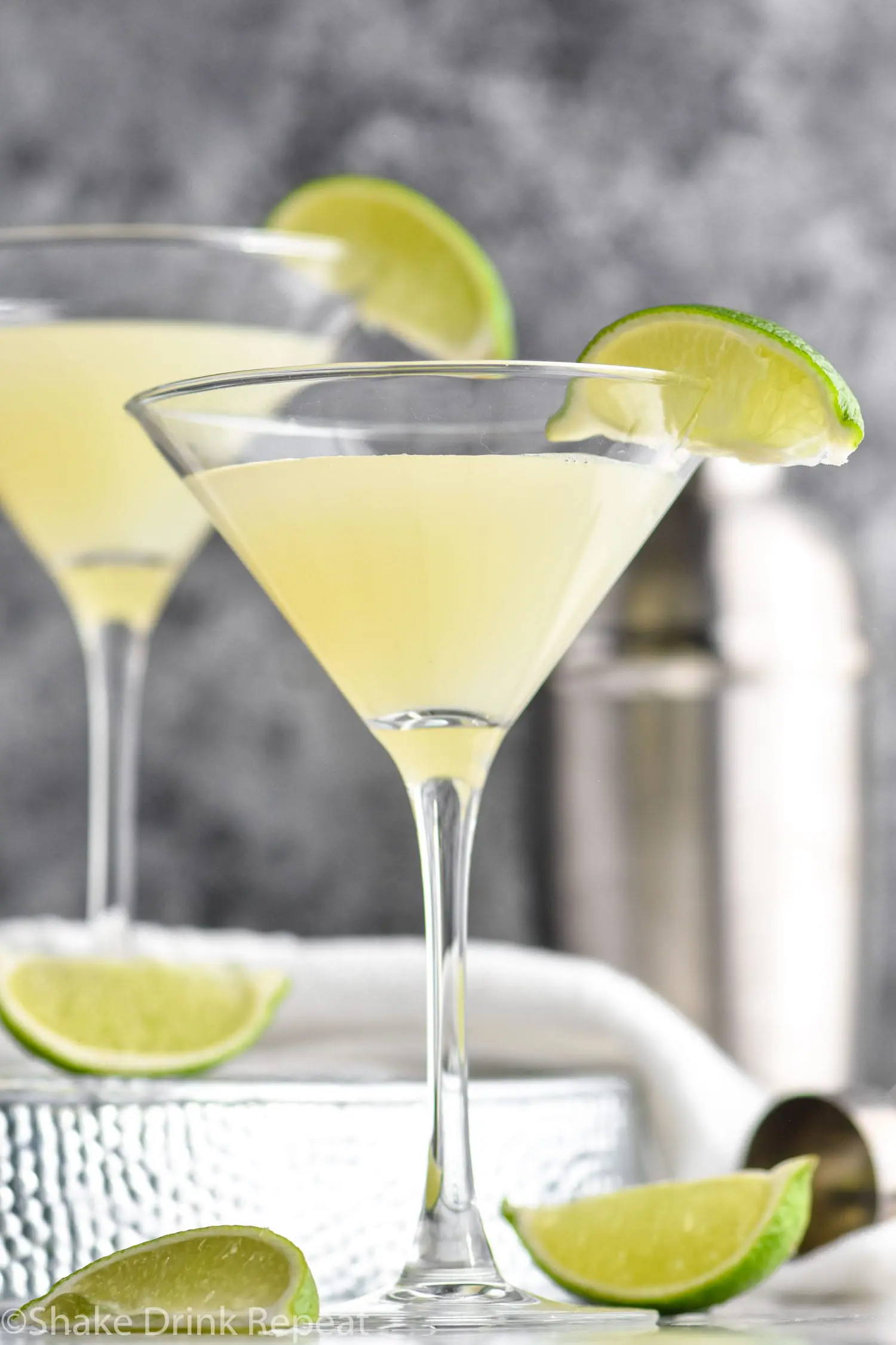 two martini glasses Kamikaze Drink with lime wedge garnish
