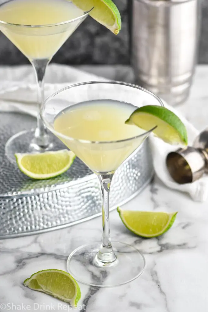 two martini glasses of Kamikaze Drink with lime wedge garnish