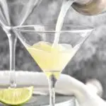 Kamikaze drink poured into a martini glass with lime wedge garnish