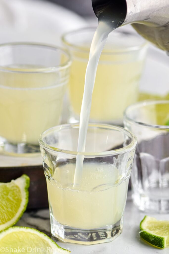 shot glasses of kamikaze shot with lime wedge garnish