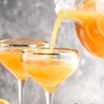 two glasses mimosa sangria recipe with orange slices and strawberries