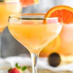 glasses of mimosa sangria with orange slice and strawberries