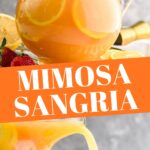 pitcher of mimosa sangria recipe with orange slices and strawberry