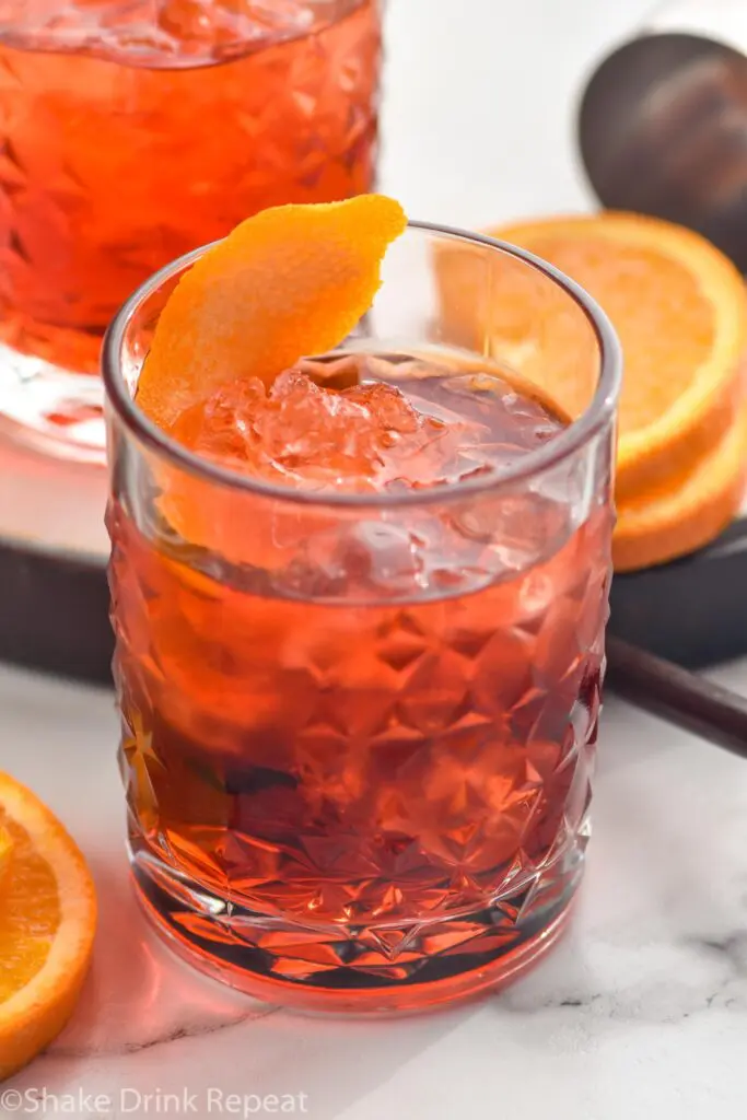 glass of Negroni drink with ice and orange twist