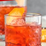 glass of Negroni cocktail with ice and orange twist