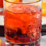 glass of Negroni cocktail with ice and orange twist