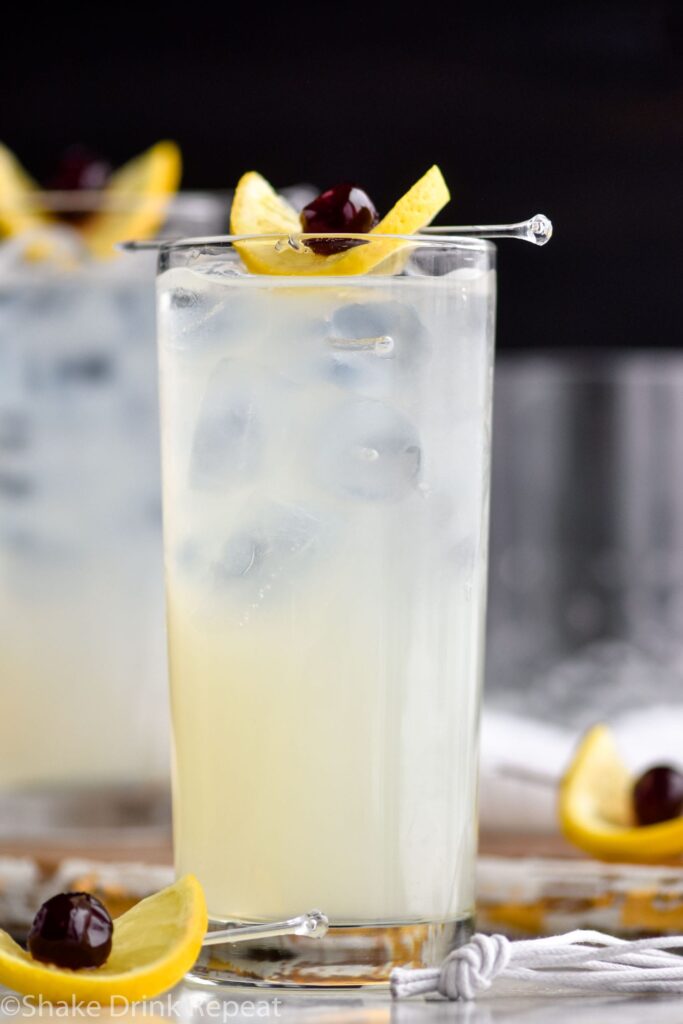 two glasses tom collins with ice, lemon, cherry