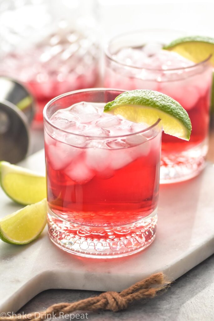 Two glasses of Vodka Cranberry recipe with ice and lime wedges
