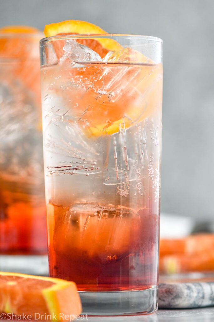 two glasses of Americano cocktail with ice and orange slice garnish