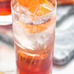 glass of Americano cocktail with ice and orange slice garnish