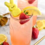 Drunk Bunny Cocktail in glass with ice, peep, lemon wedge and strawberry.