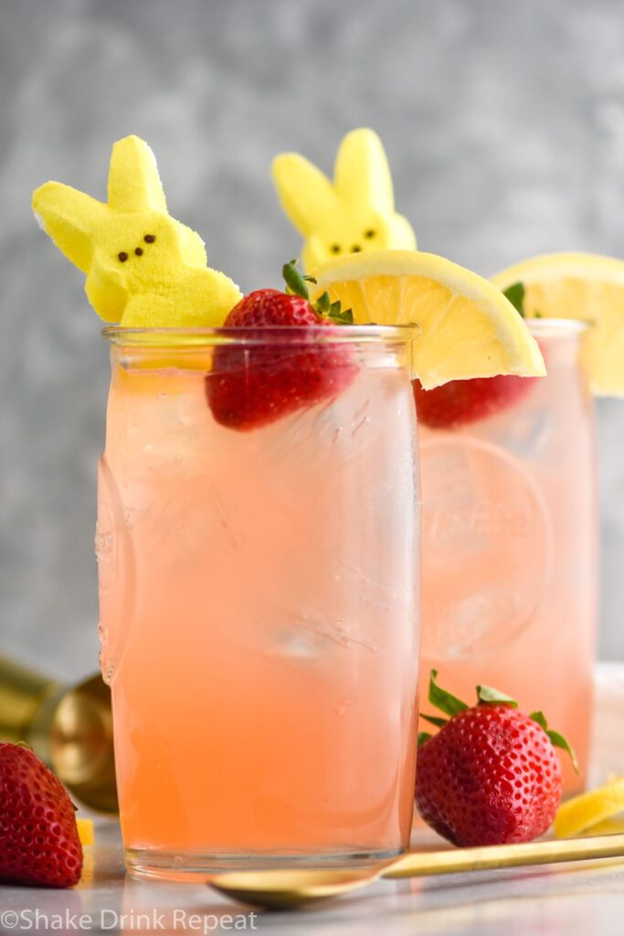 Drunk Bunny Cocktail in glass with ice, peep, lemon wedge and strawberry.