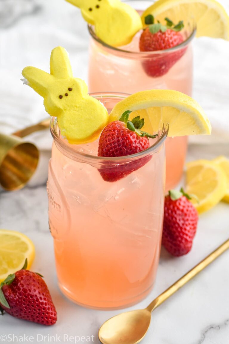 Drunk Bunny Cocktail in glass with ice, peep, lemon wedge and strawberry.