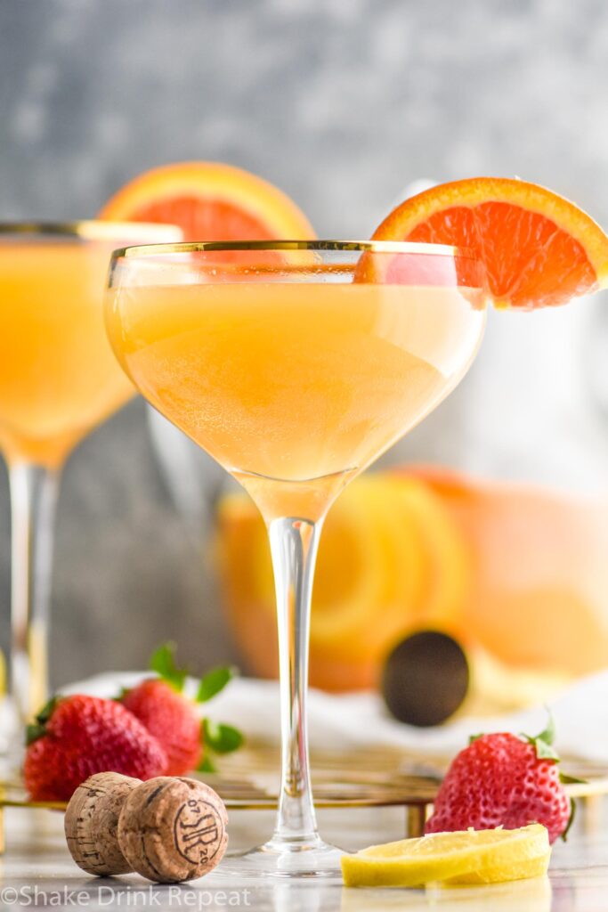 two glasses mimosa sangria with orange slices and strawberries