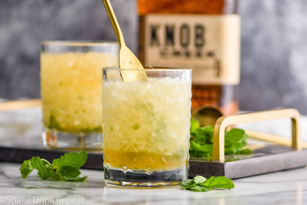 two glasses of mint julep cocktail with bourbon and ice