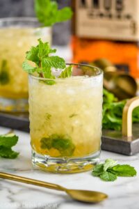 glass of mint julep cocktail with ice and bourbon