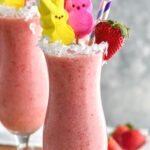 Bunny Colada in a glass with strawberries, coconut and peeps garnishing it with a straw