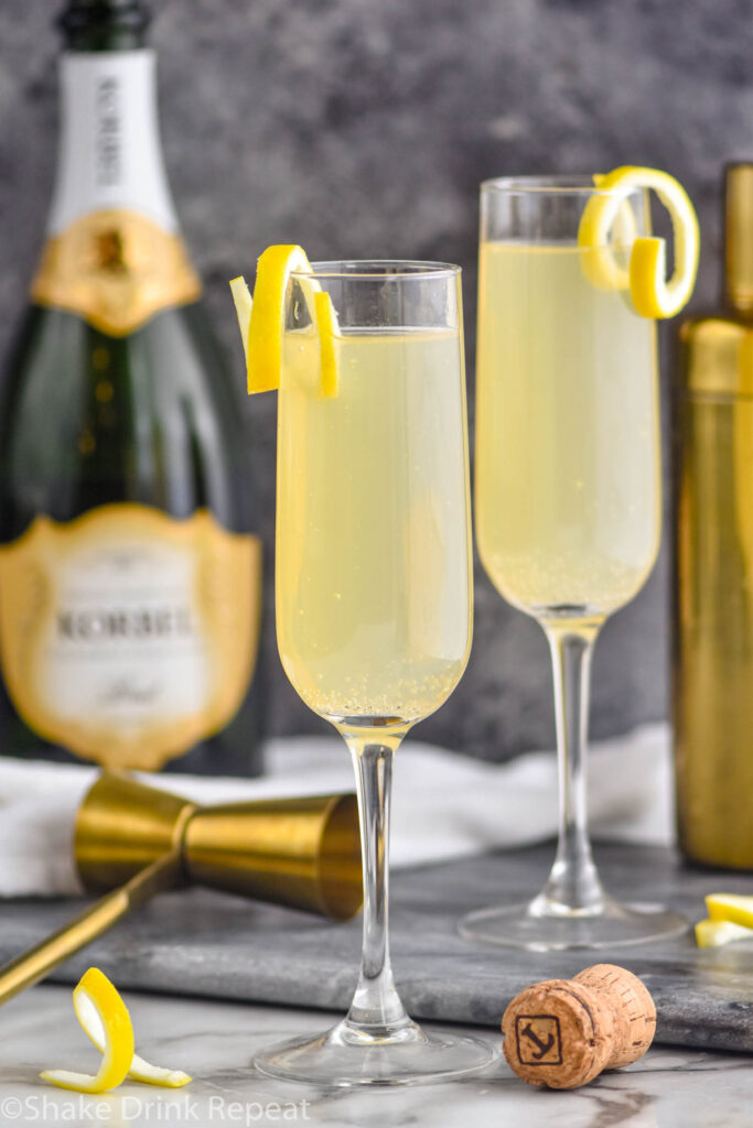 two glasses of french 75 with lemon twist and champagne