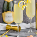 two glasses of french 75 with lemon twist and champagne